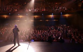 Photograph of comedian on stage at Balboa Theatre