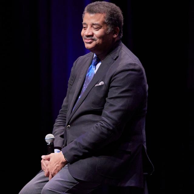 Dr. Neil deGrasse Tyson at San Diego Civic Theatre, by Karen Floyd Portraits Dr. Neil DeGrasse Tyson looking offstage, smiling, microphone in hand