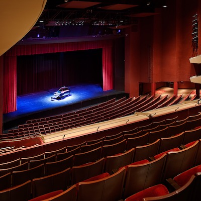 Photograph of a stage before a performance, perspective is from lower left side of audience